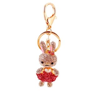 Portachiavi con coniglio di strass scintillanti, telaio dorato e vestito rosso acceso