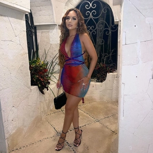 Detailed back view of a slim-fit halter neck dress with vibrant multi-color gradient stripes