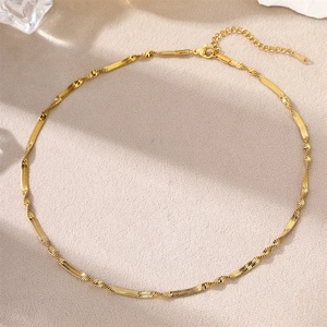 Detailed close-up of a gold-plated stainless steel twisted snake chain necklace detail