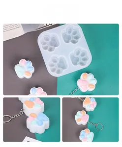 Detail of 4-cavity cat paw silicone mold with macaron color resin keychains