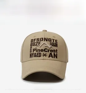 Detail of khaki twill cotton baseball cap with mountain embroidery and decorative stitching