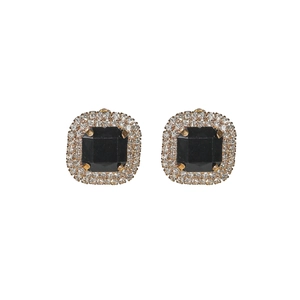 Macro detail of square black gemstone earrings with sparkling crystal halo and gold base