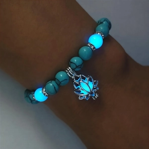 Luminous turquoise bead bracelet with a glowing silver lotus pendant for yoga energy