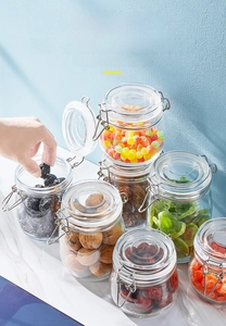 Close-up of glass storage jars with airtight metal buckles and silicone seals for food