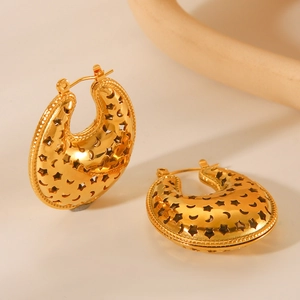 Golden stainless steel hoop earrings with hollow star and moon patterns on beige display