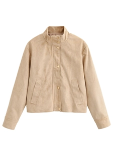 Close-up of beige suede jacket showing soft fabric texture and metallic snap buttons