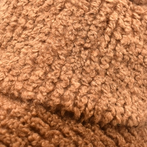 Close-up of soft brown corduroy and sherpa fleece texture for winter bucket hats