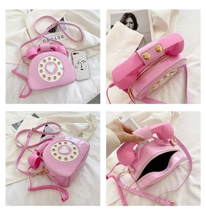 Detail shots of pink vintage telephone bag with heart dial design and glossy finish