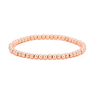 Close-up of polished rose gold beaded elastic bracelet with high shine finish