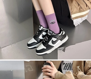 Detail of purple ribbed socks with EST.2010 embroidery paired with stylish street sneakers