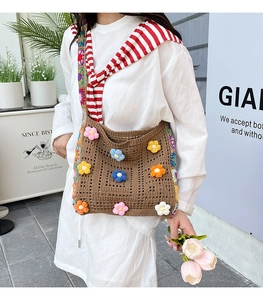 Close-up of brown crochet tote bag with colorful 3D knit flowers and handmade texture