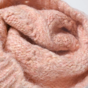 Thick peach pink knitted beanie with warm ribbed texture and soft wool fibers