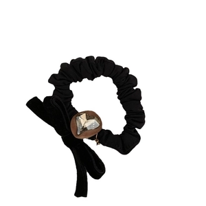 Elegant black velvet hair tie with a bow and heart-shaped crystal ornament
