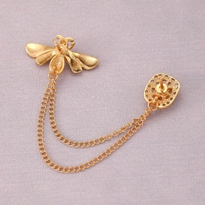 Detail view of the back showing double pin fasteners on the gold bee collar brooch