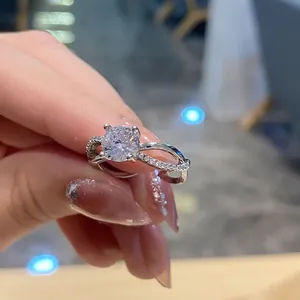 Close-up of infinity band engagement ring with a round-cut diamond in four-prong setting