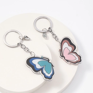 Close-up of heart magnet butterfly keychains on white circular display stands
