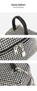Detail of silver rhinestone evening bag with leather handle and metallic chain strap