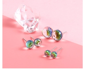 Macro shot of three pairs of S925 silver stud earrings with colorful crystal spheres