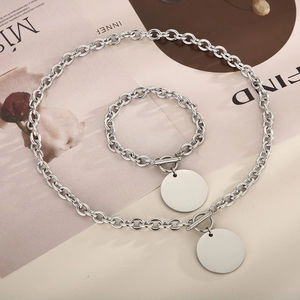 Close-up of titanium steel O-chain necklace and bracelet set with polished round pendants