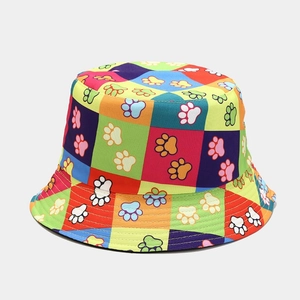Close-up of colorful checkered bucket hat featuring cartoon paw prints and wide brim