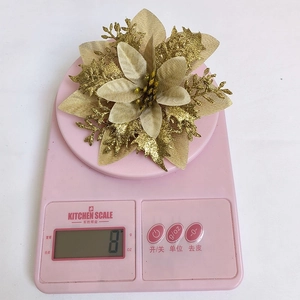 Close-up of a 14cm champagne gold glitter poinsettia flower weighing 8g for decor