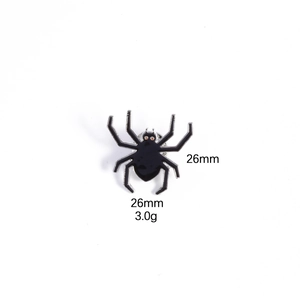 Detailed close-up of a black spider enamel brooch with silver edges and 26mm size marking
