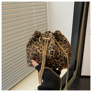 Detail of leopard print bucket bag with drawstring closure and gold chain strap