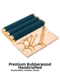 Disassembled parts of a 4-tier wooden jewelry stand with green velvet rolls and gold bars