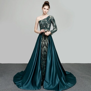 Detailed view of the dark green sequin embroidery and satin detachable train on gown