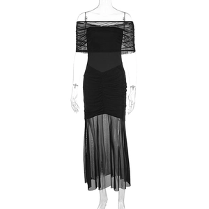 Detail of ruched black bodycon dress featuring sheer mesh patchwork and a fishtail hemline