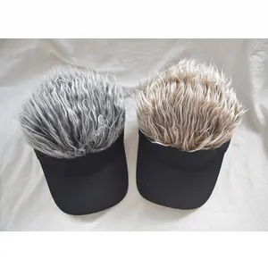 Detailed top view of wig visor caps with gray and light brown hair on black brims