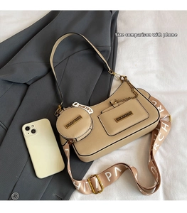 Detailed view of beige tote bag set with metal chain and logo printed wide strap