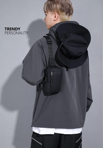 Waterproof black crossbody chest bag shown on model with adjustable strap detail