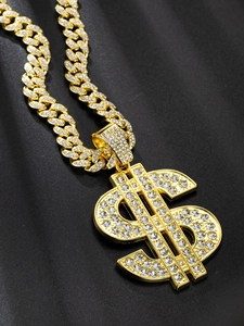 Detailed view of a golden dollar sign pendant with sparkling rhinestones on Cuban link chain
