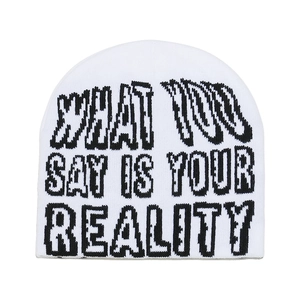Detail of white knit beanie featuring black letter jacquard pattern and texture