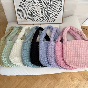 Bubble texture tote bags in seven colors displayed against a minimalist home background