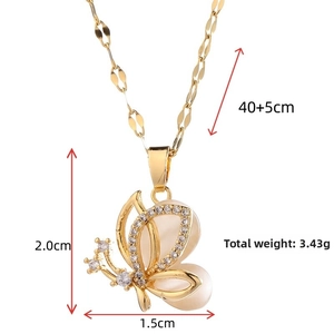 Detail view of gold butterfly pendant with cat eye stone and cubic zirconia accents