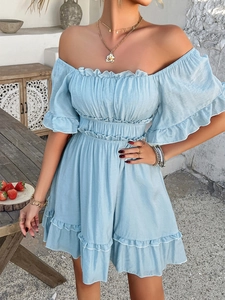 Detail of light blue off-shoulder dress featuring ruffled edges and shirred elastic waist