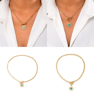 Detail view of gold flower necklaces featuring sun and square turquoise stone pendants