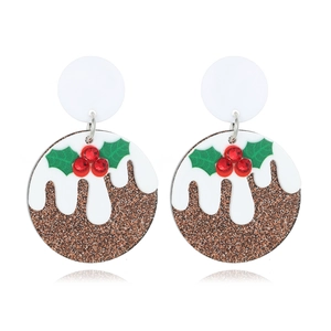 Festive Christmas pudding earrings with brown glitter and holly leaves on white background