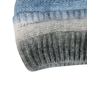 Macro detail of thick knit gradient fabric in blue and grey showing high-quality yarn texture