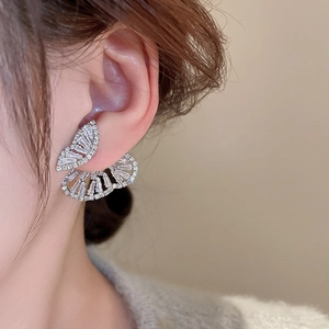 Detail of silver needle zircon butterfly earrings shown on model with sparkling stones