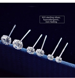 Macro detail of six round zircon stud earrings in 925 sterling silver four-prong setting
