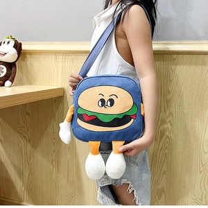 Blue burger shaped canvas bag with cute cartoon face and 3D plush limbs shown on a model