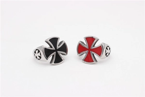 Detail of cross rings with red and black enamel insets on polished titanium steel