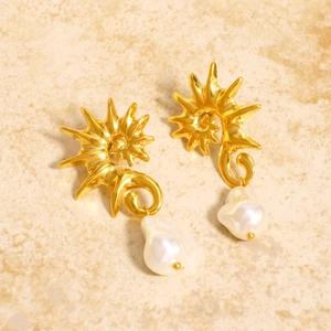 Retro 18K gold seahorse pearl earrings with baroque style on beige stone background