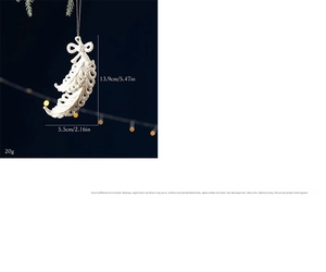 Detailed view of pearl white feather ornament with glitter and silver hanging cord