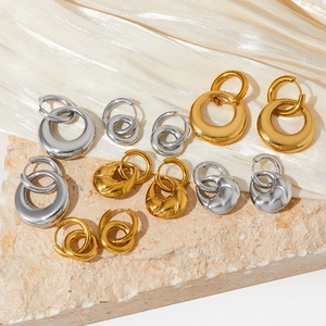 PVD gold plated double hoop earrings in gold and silver finish on textured stone