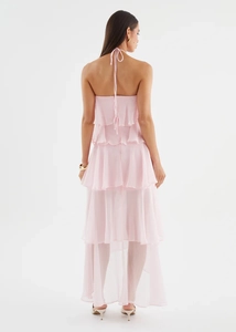 Back view of a pink tiered halter dress featuring an open back and flowing layered skirt