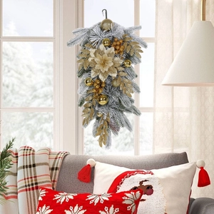 Close-up of luxury flocked Christmas teardrop wreath with gold balls and flowers